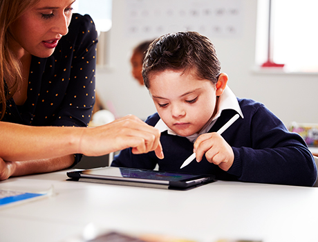 SEND student using ipad with teacher