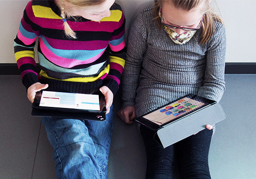 Two teenagers doing homework on iPad