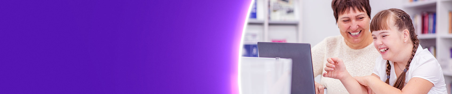 Teacher with SEN pupil at laptop