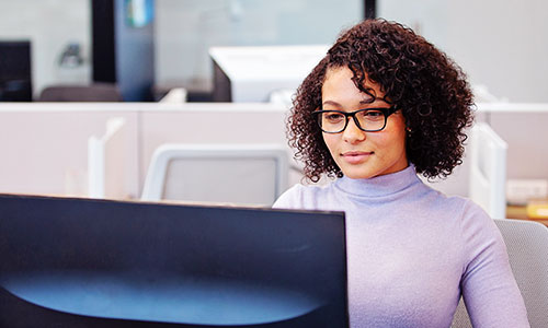 Woman working on a computer glasses
