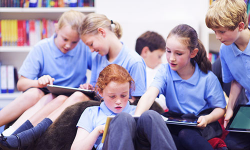 Lots of children using tablets in school