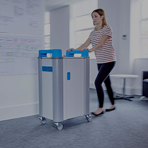 Teacher pushing laptop trolley to classroom