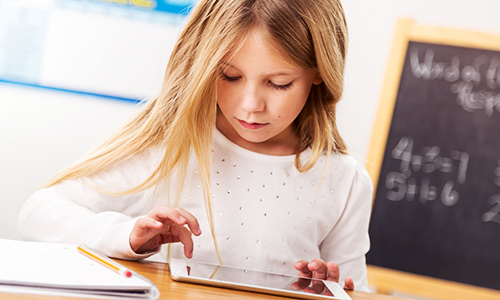 female student using mobile device in the classroom