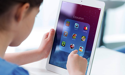 Female student using mobile device in classroom
