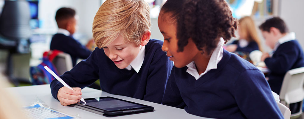 Students in classroom using modern mobile device