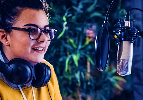 A young women in a recording studion with a headset